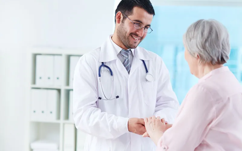 Doctor holding the hands of a senior woman