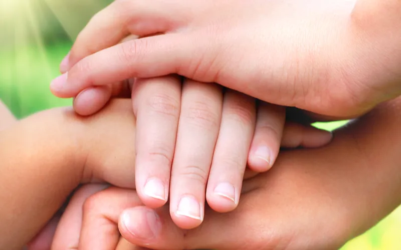 Hands joined together in support