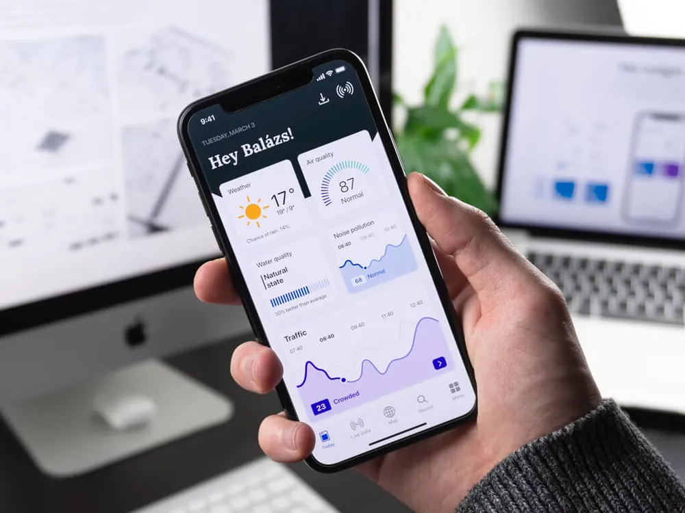 Hand holding a smartphone showing an update